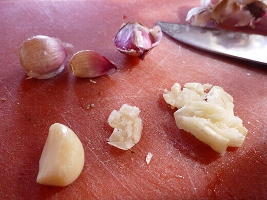 Peel and smash garlic cloves