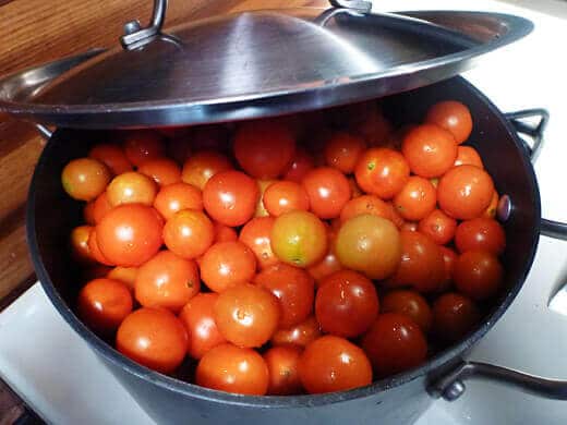 Dump cherry tomatoes into a big pot