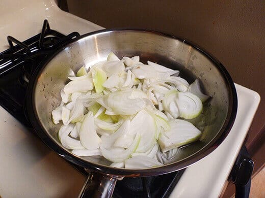 Add onion slices and stir to coat them evenly in oil