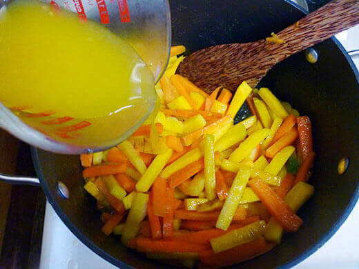 Pour in orange juice and simmer