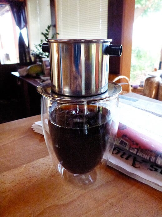 Single-cup slow drip of dark French roast coffee