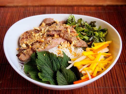 Vietnamese daikon and carrot pickles in a bowl of vermicelli and grilled pork