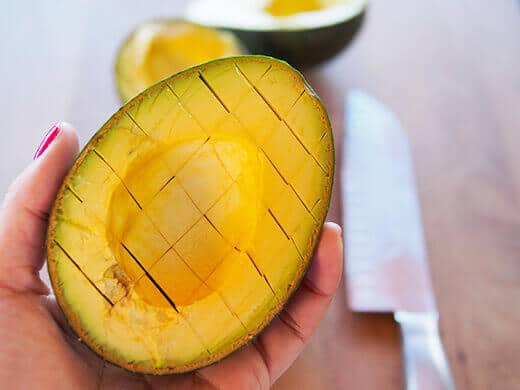 Make criss-cuts in the avocado flesh for easier scooping and mashing
