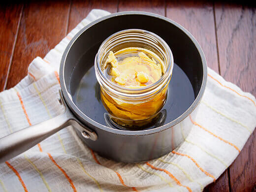 Combine walnut oil and beeswax in pint jar