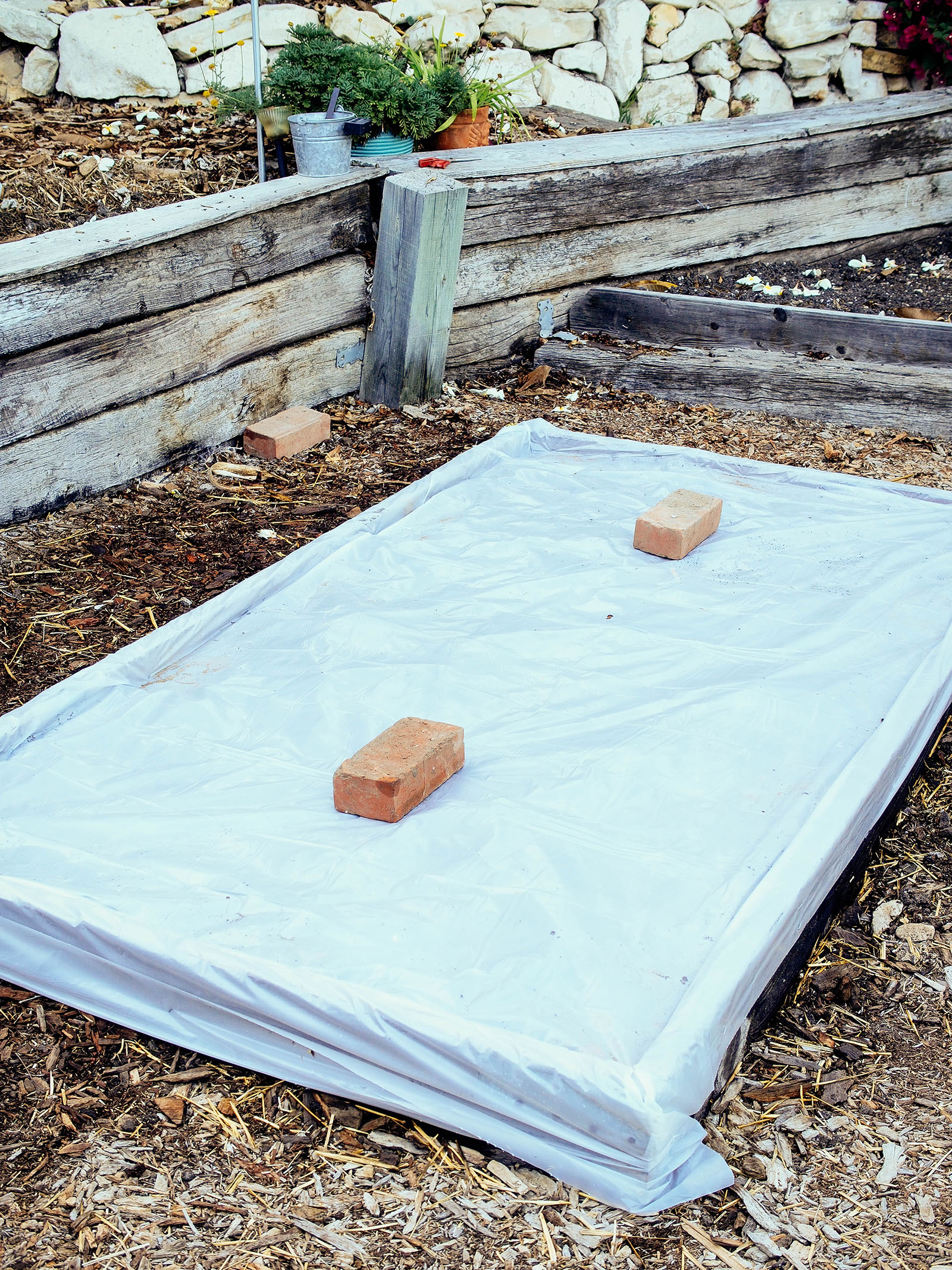 Raised bed wrapped in plastic