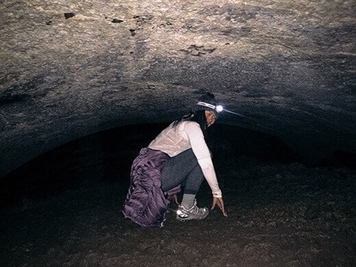 Crawling through the lowest section of the cave