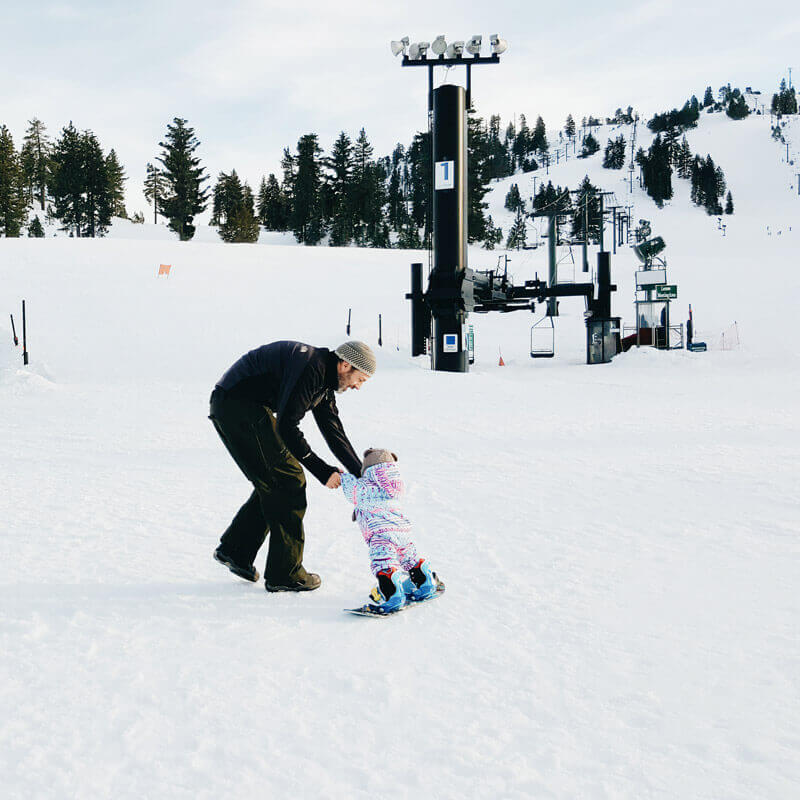 Baby learning to snowboard