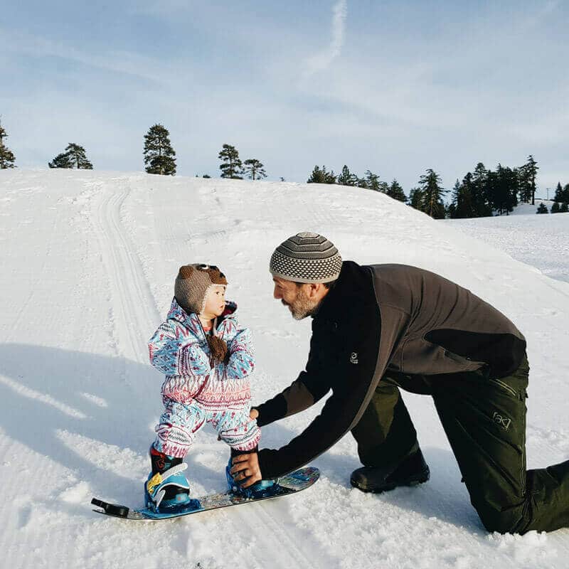 Teaching a toddler to snowboard