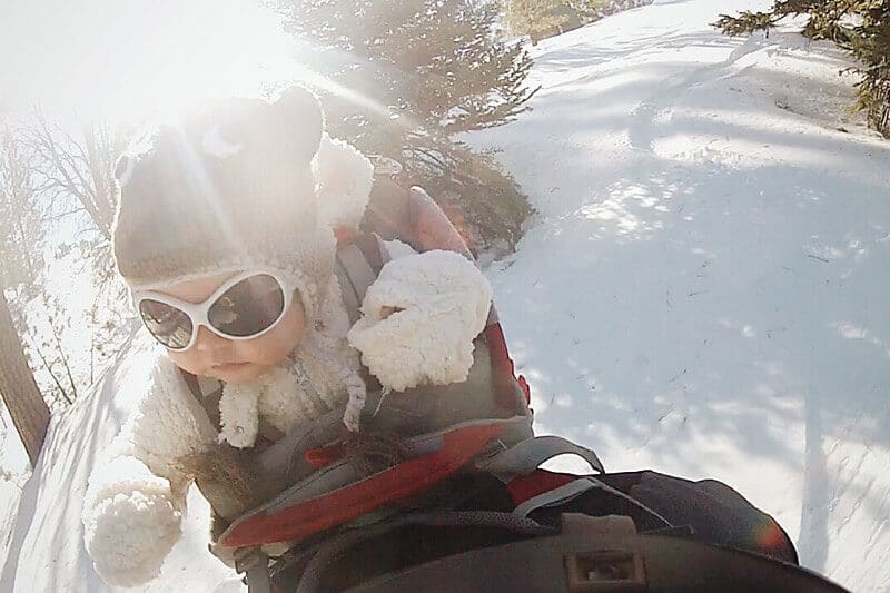 Snowboarding with a baby in a backpack