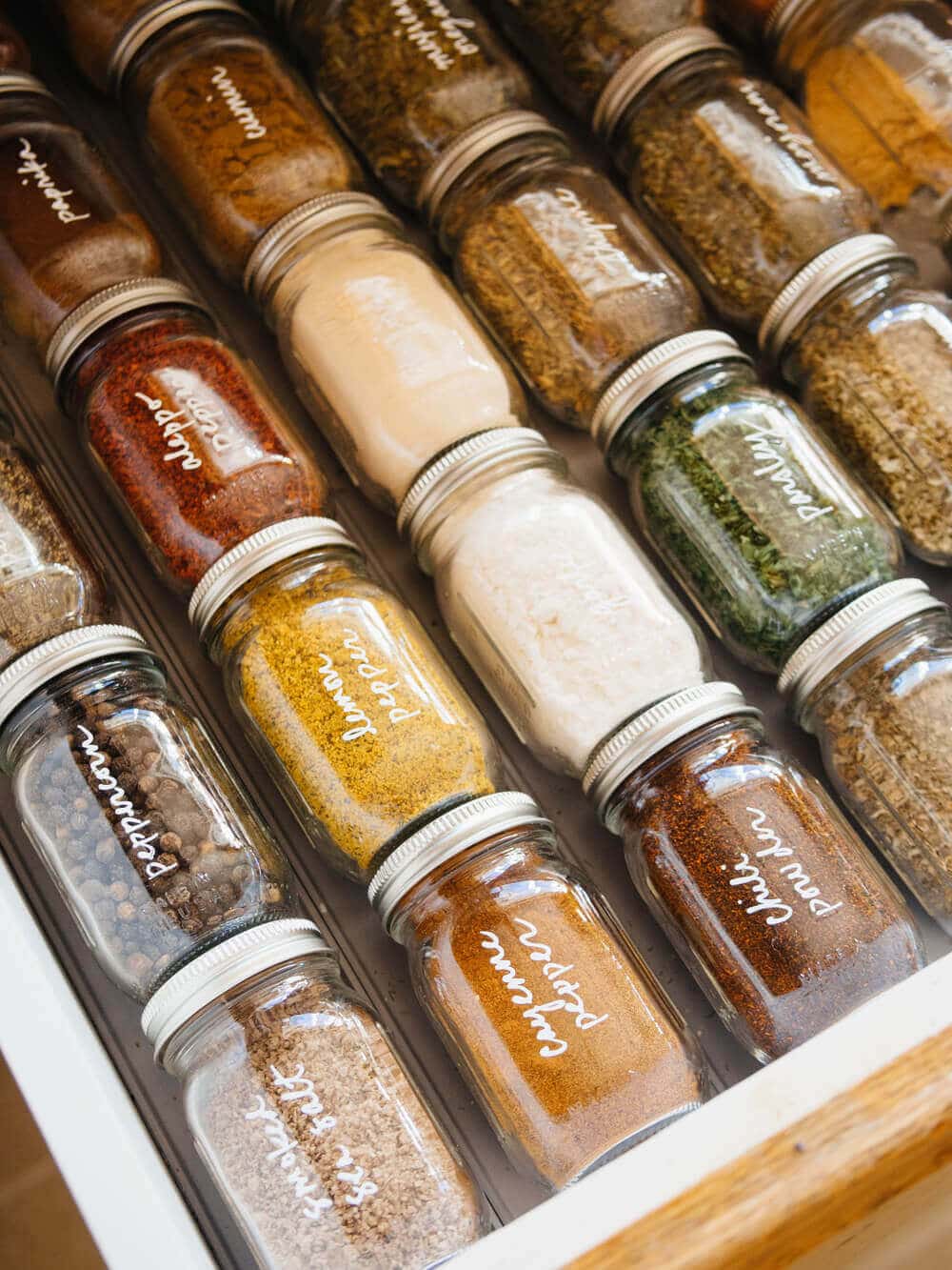 An organized collection of spices in a drawer