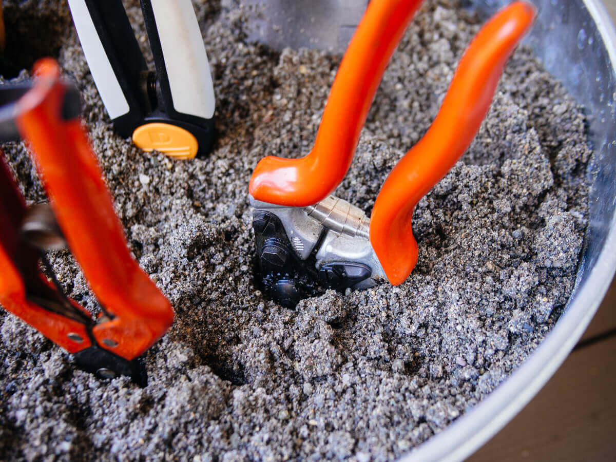 Gardening hand tools can easily be maintained in a bucket of sand mixed with oil
