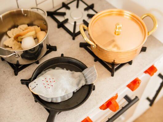 "Concrete" counters, mini cast iron pan, and mini copper pot in a play kitchen