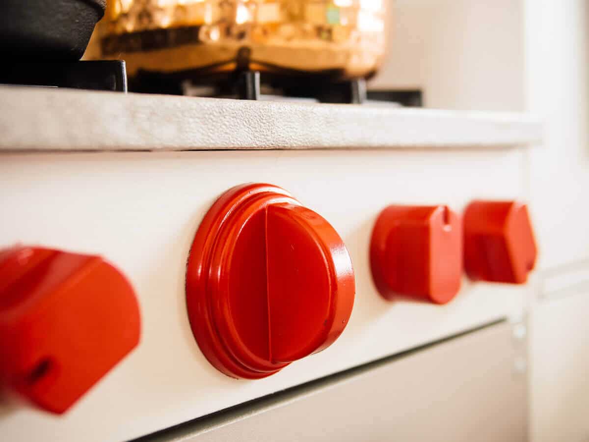Red knobs on a play kitchen stove range