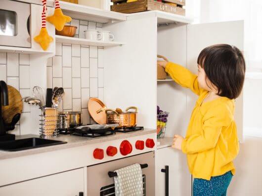 Playing in her new kitchen