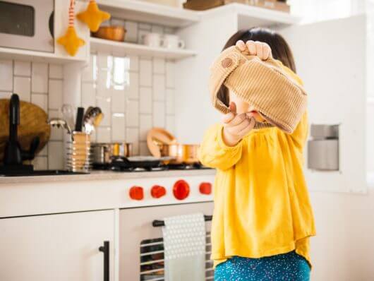 Goofing off in her play kitchen