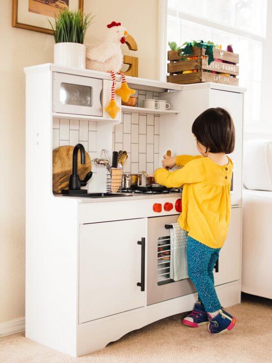 Playing in her newly "remodeled" toy kitchen