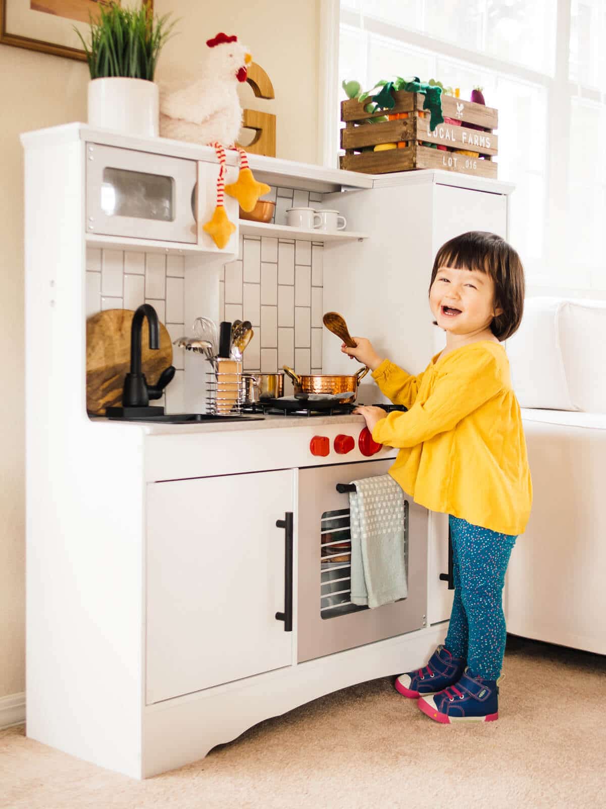 Cooking in her remodeled KidKraft play kitchen