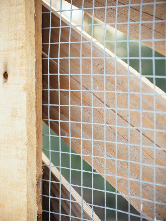 Heavy-gauge hardware cloth on chicken run fencing