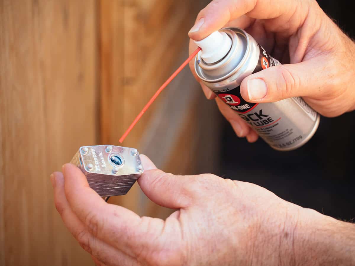 Apply 3-IN-ONE Lock Dry Lube to a lock to remove grime