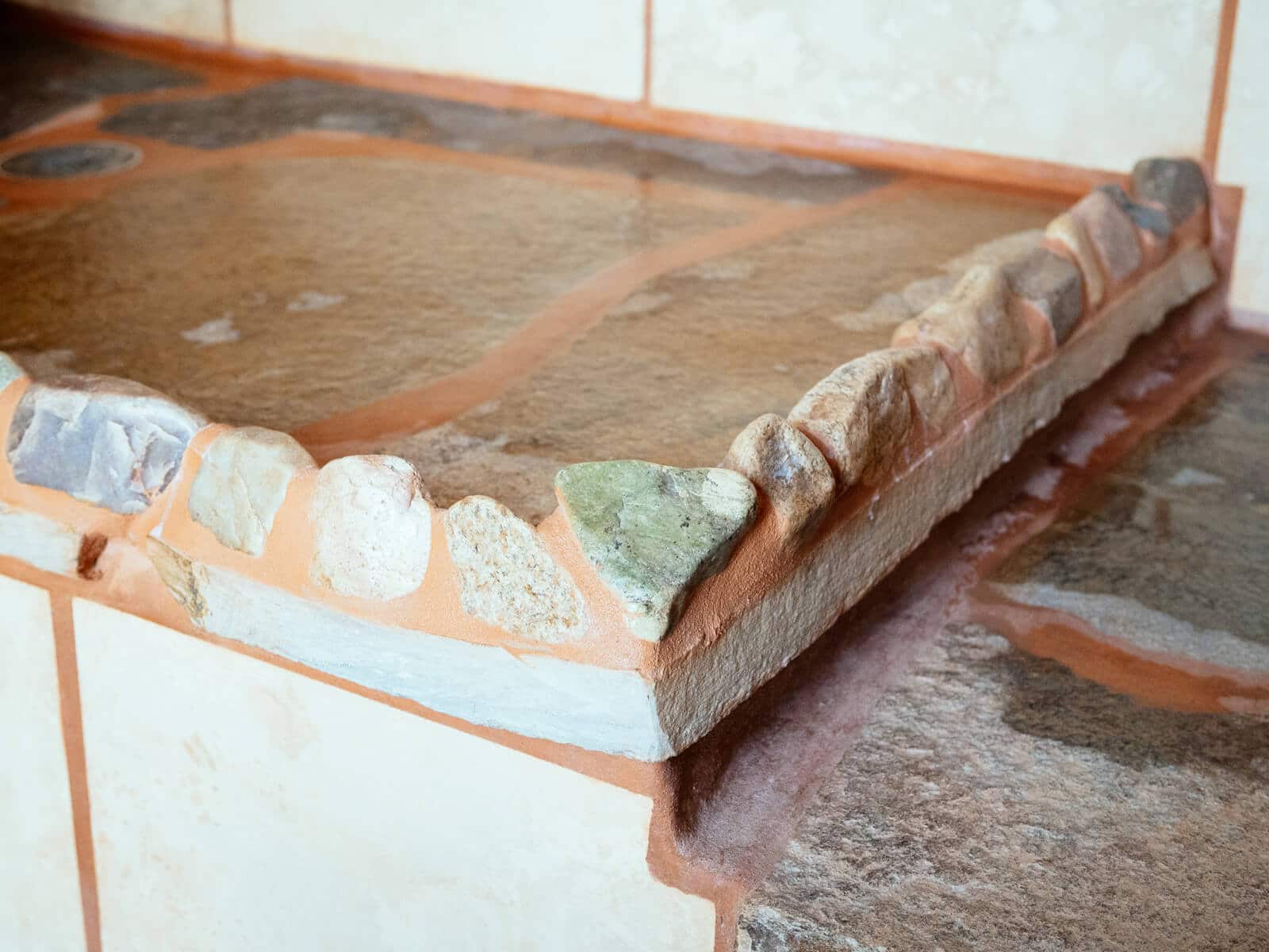 Custom stone work in an Earthship bathroom