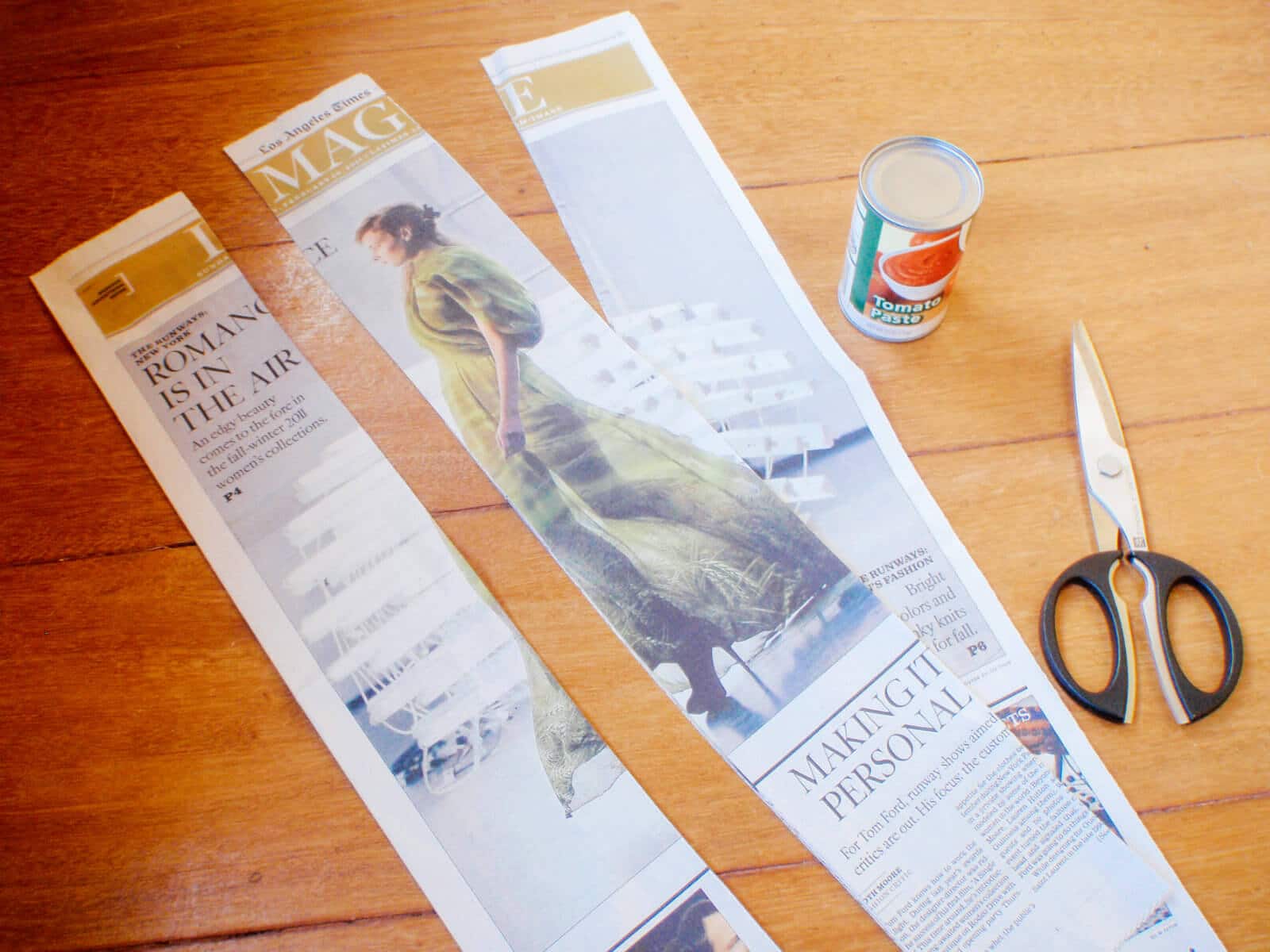 Cut the newspaper into thirds lengthwise