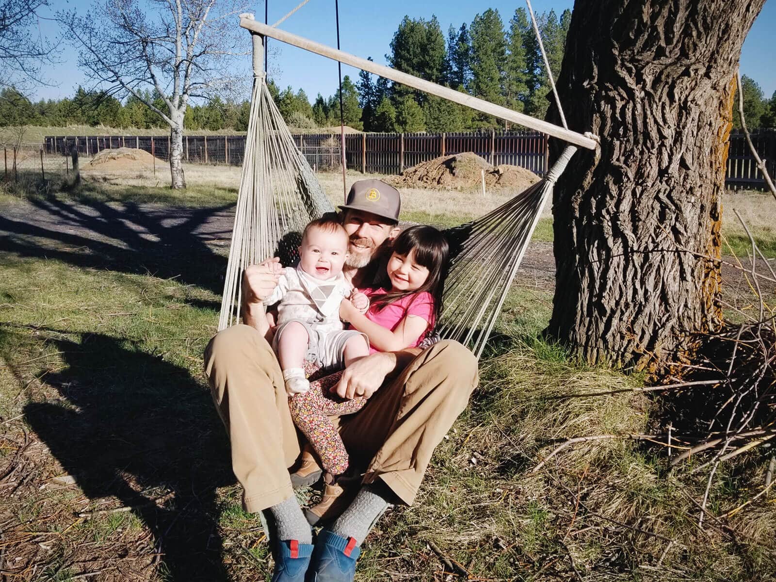 Dad and daughters on a tree swing