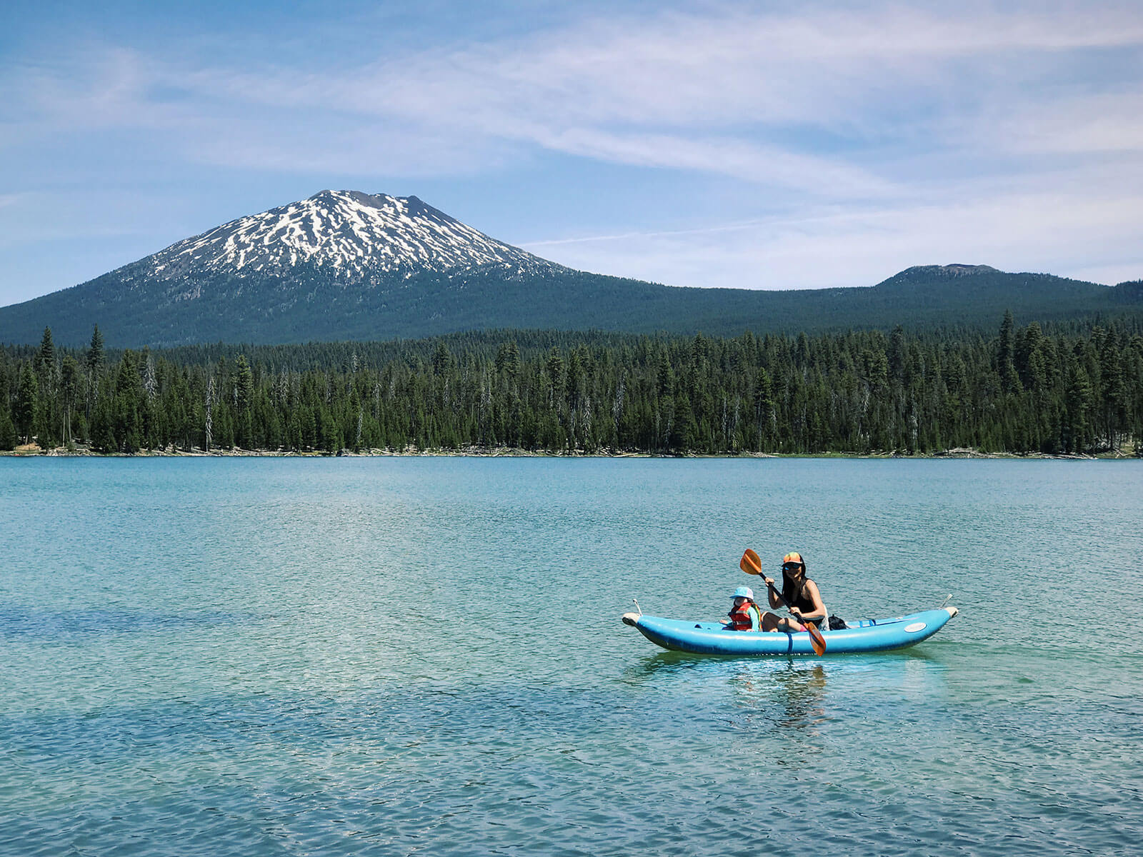 Kayaking at Lava Lake in Bend, Oregon with a view of Mount Bachelor in the background