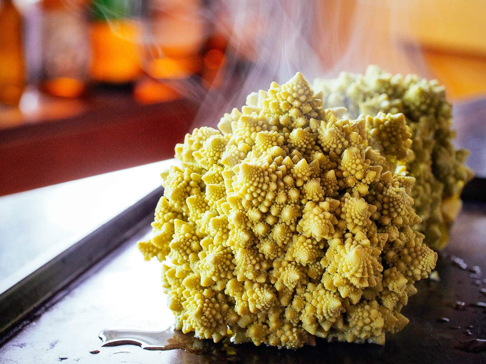 A steaming head of Romanesco broccoli out of the oven