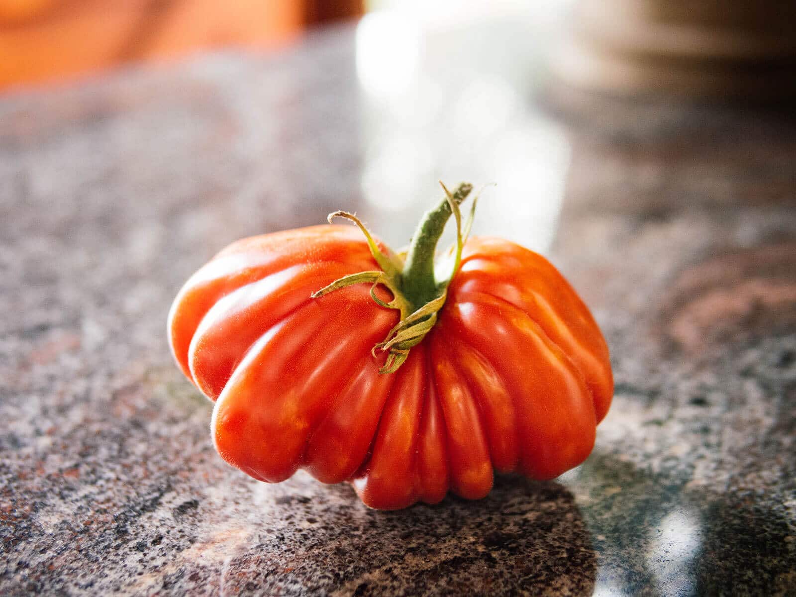 A fully ripe red tomato with mature seeds inside
