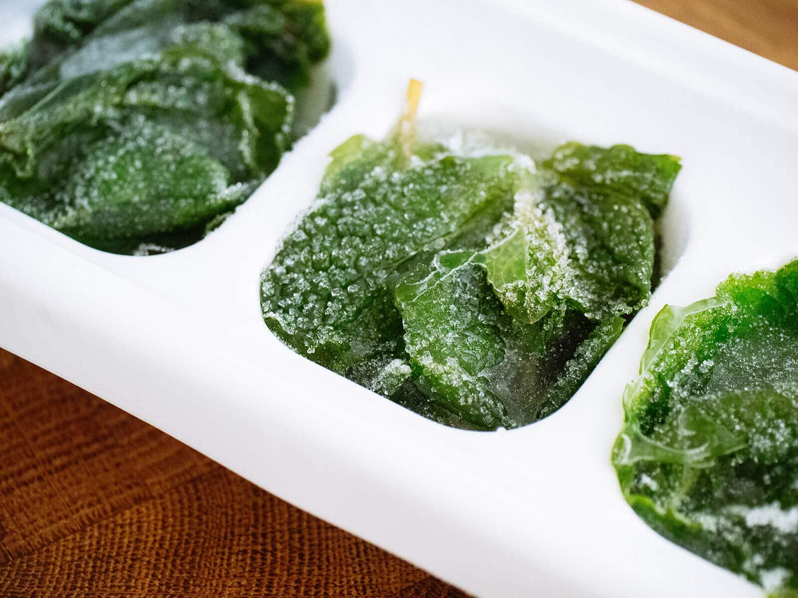 Freezing mint leaves in an ice cube tray with water