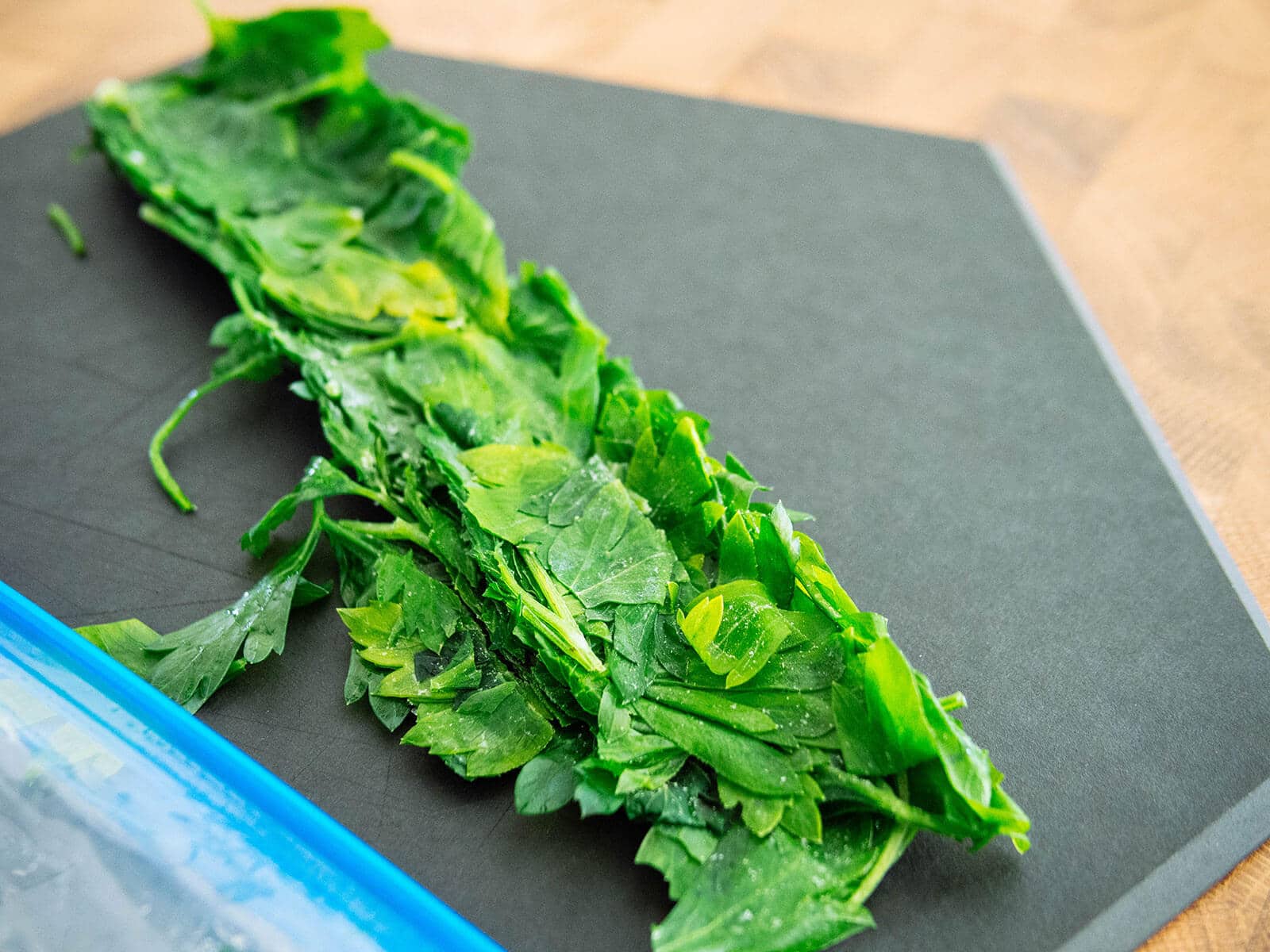 Frozen portion of parsley pulled out onto a cutting board