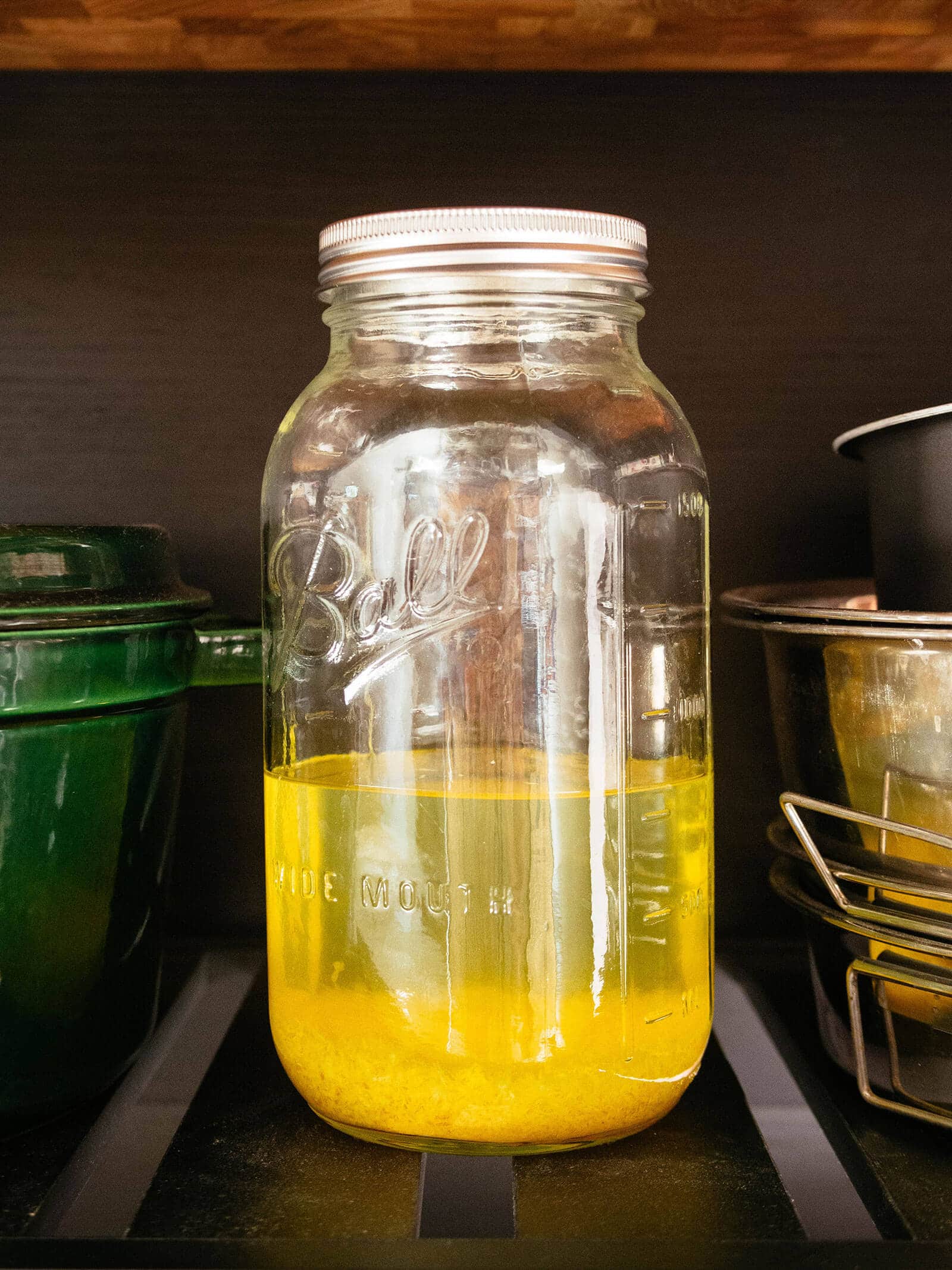 Jar of Everclear alcohol being infused with lemon zest