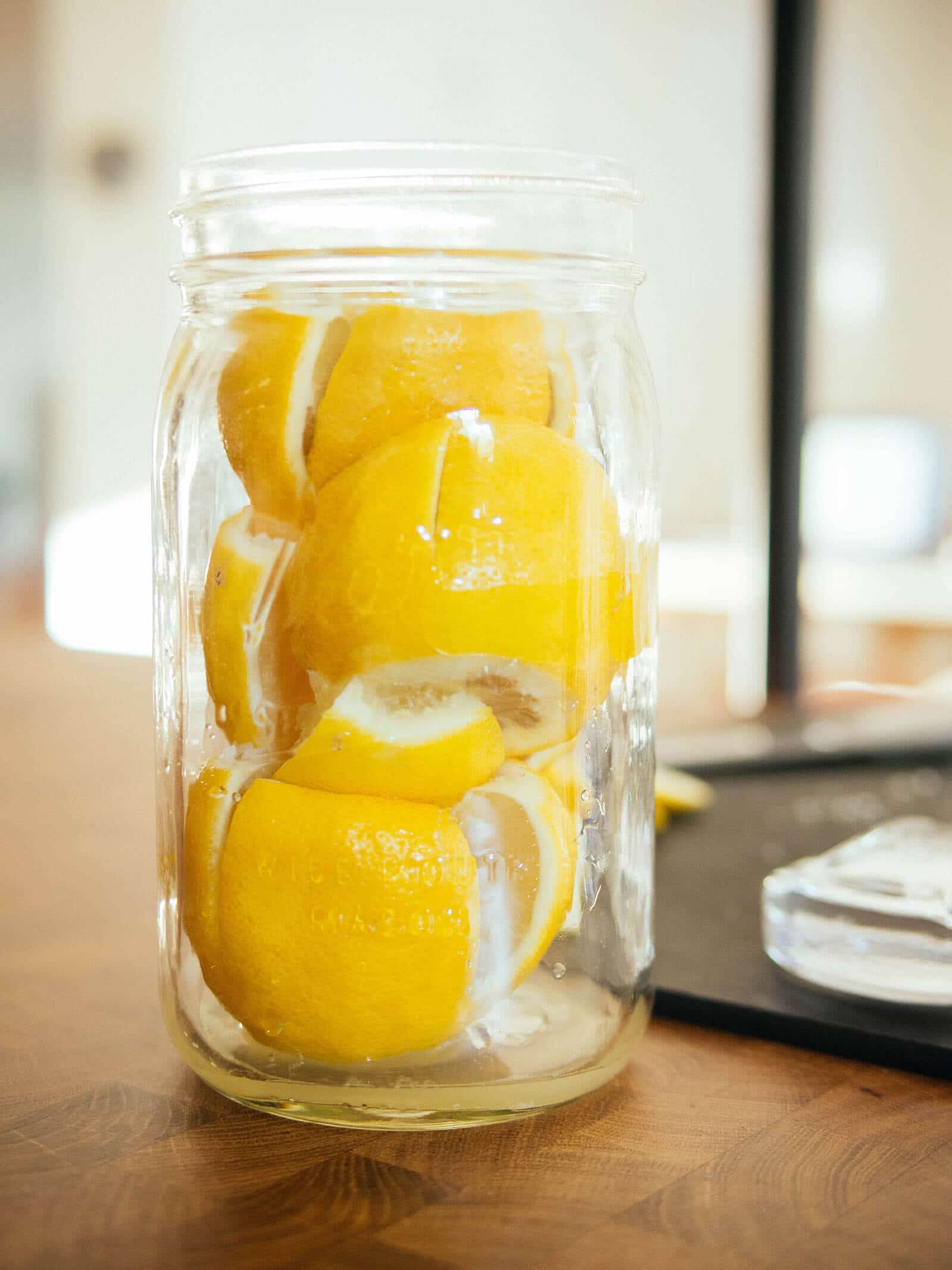 Salted lemons packed into an empty mason jar