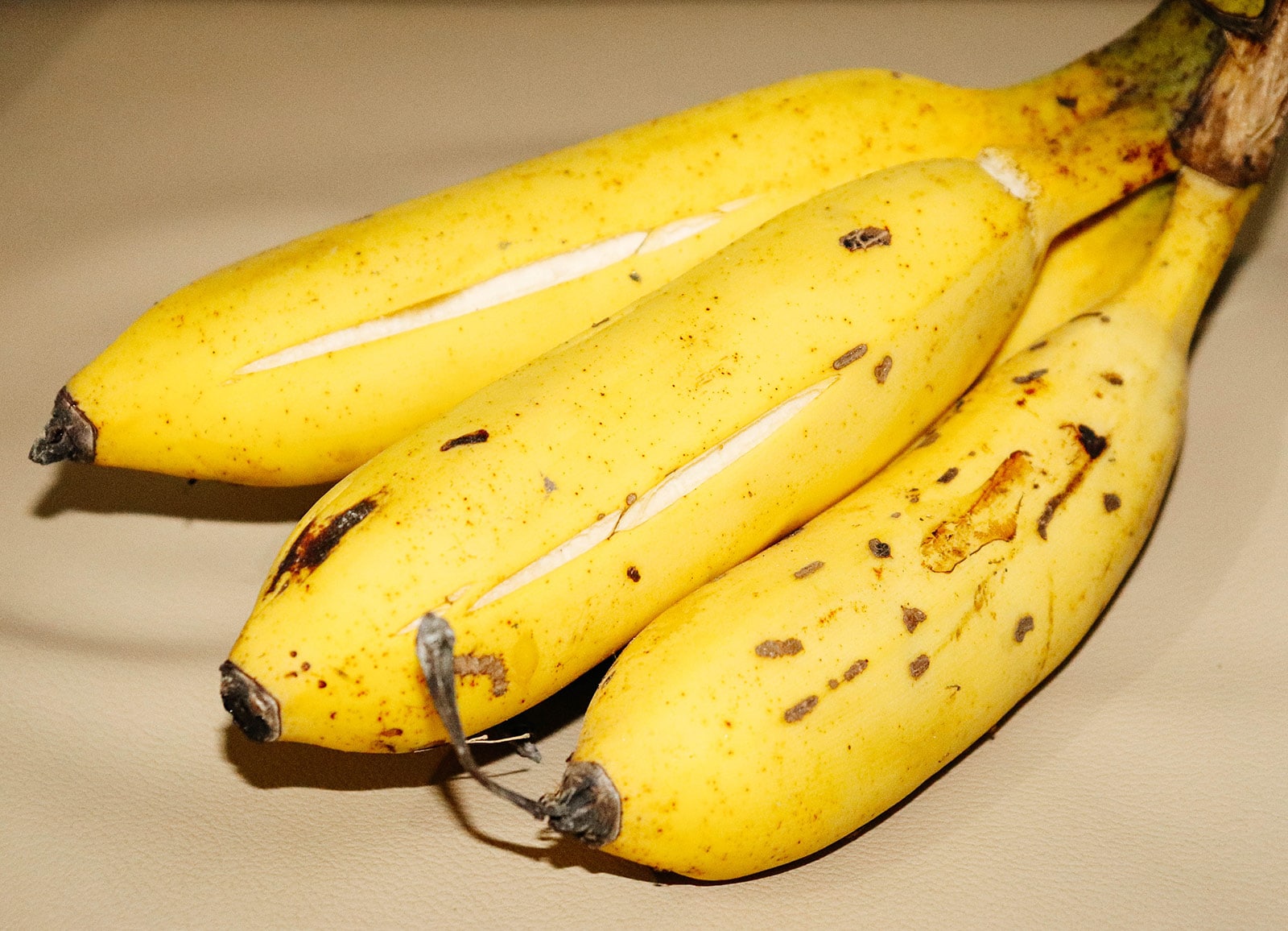 Ripe bananas with split open peels