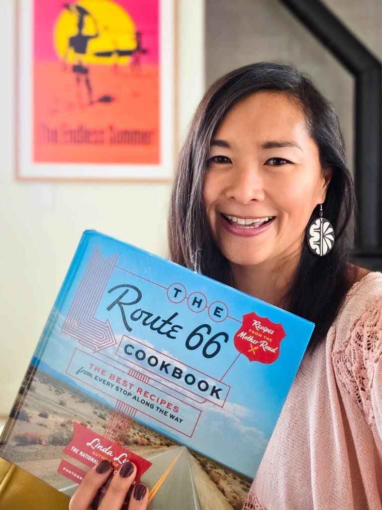 Linda Ly holding a copy of The Route 66 Cookbook