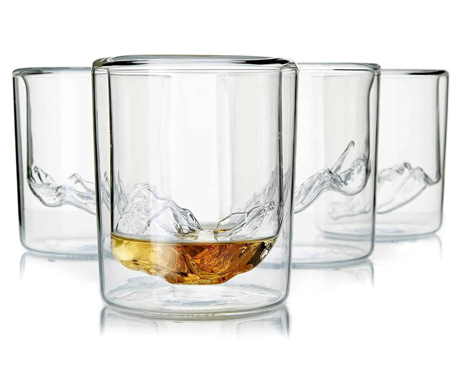 Bar glasses with topographic impressions of national park mountains