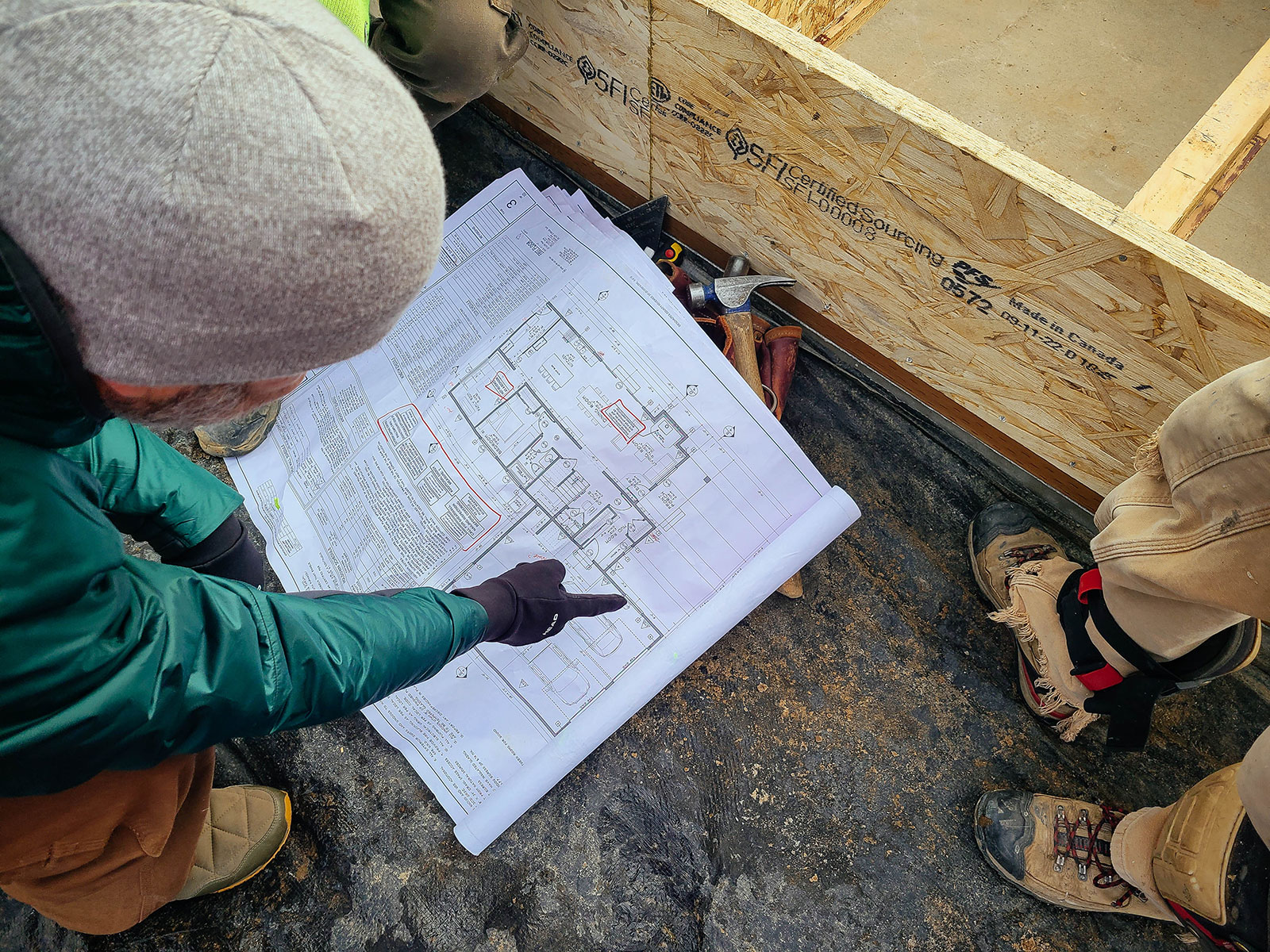 Man pointing to blueprints at a construction site