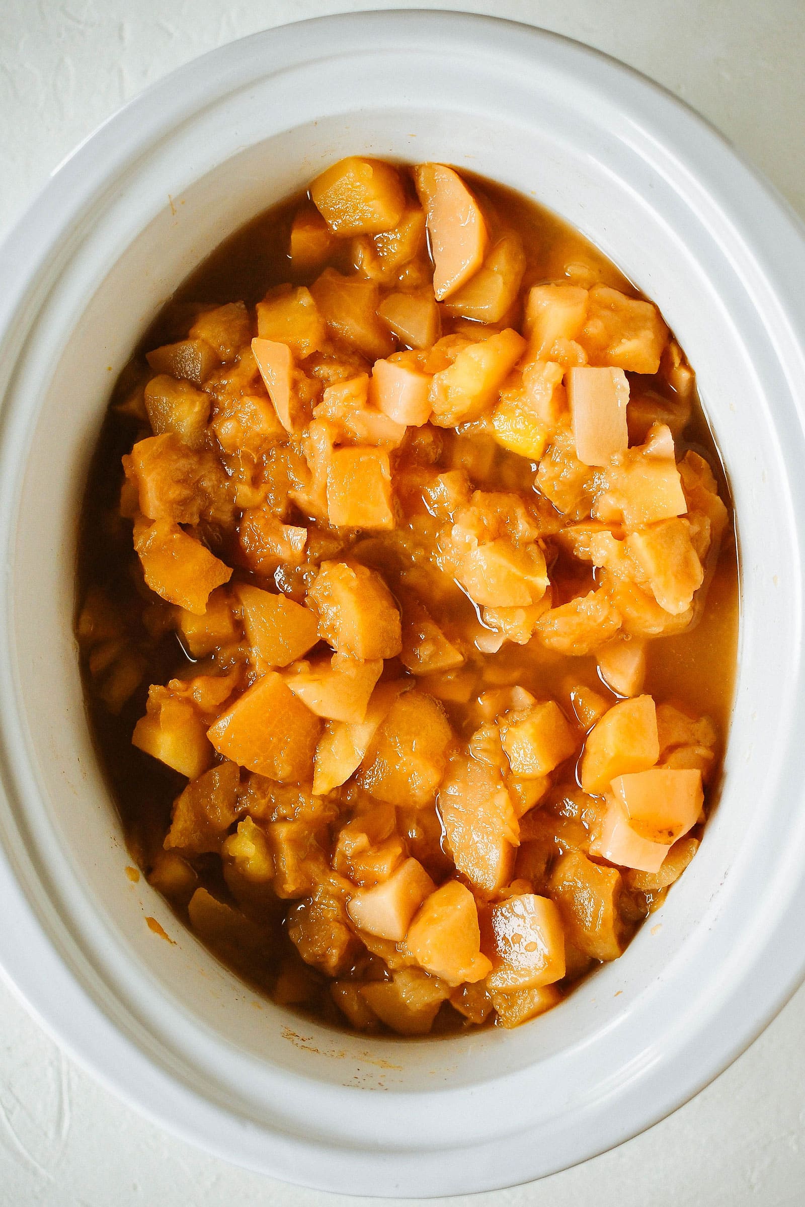 Slow cooker filled with chunky apple and pear mixture