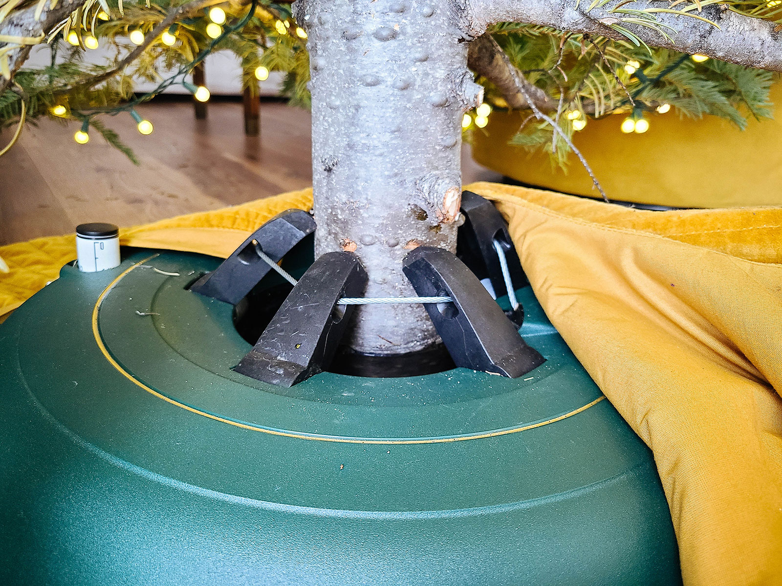 Large green tree stand holding a fir tree trunk