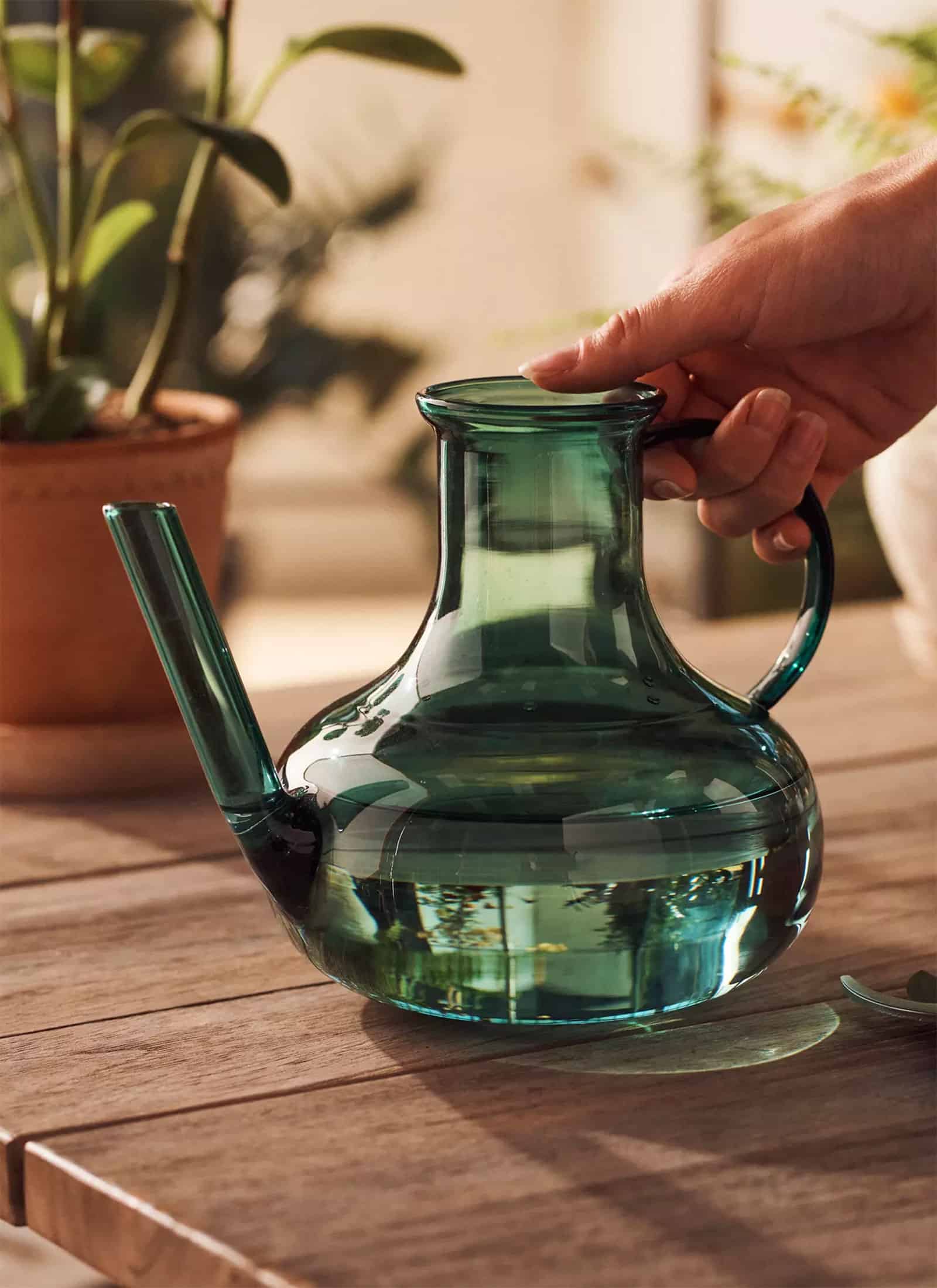 Green glass watering can