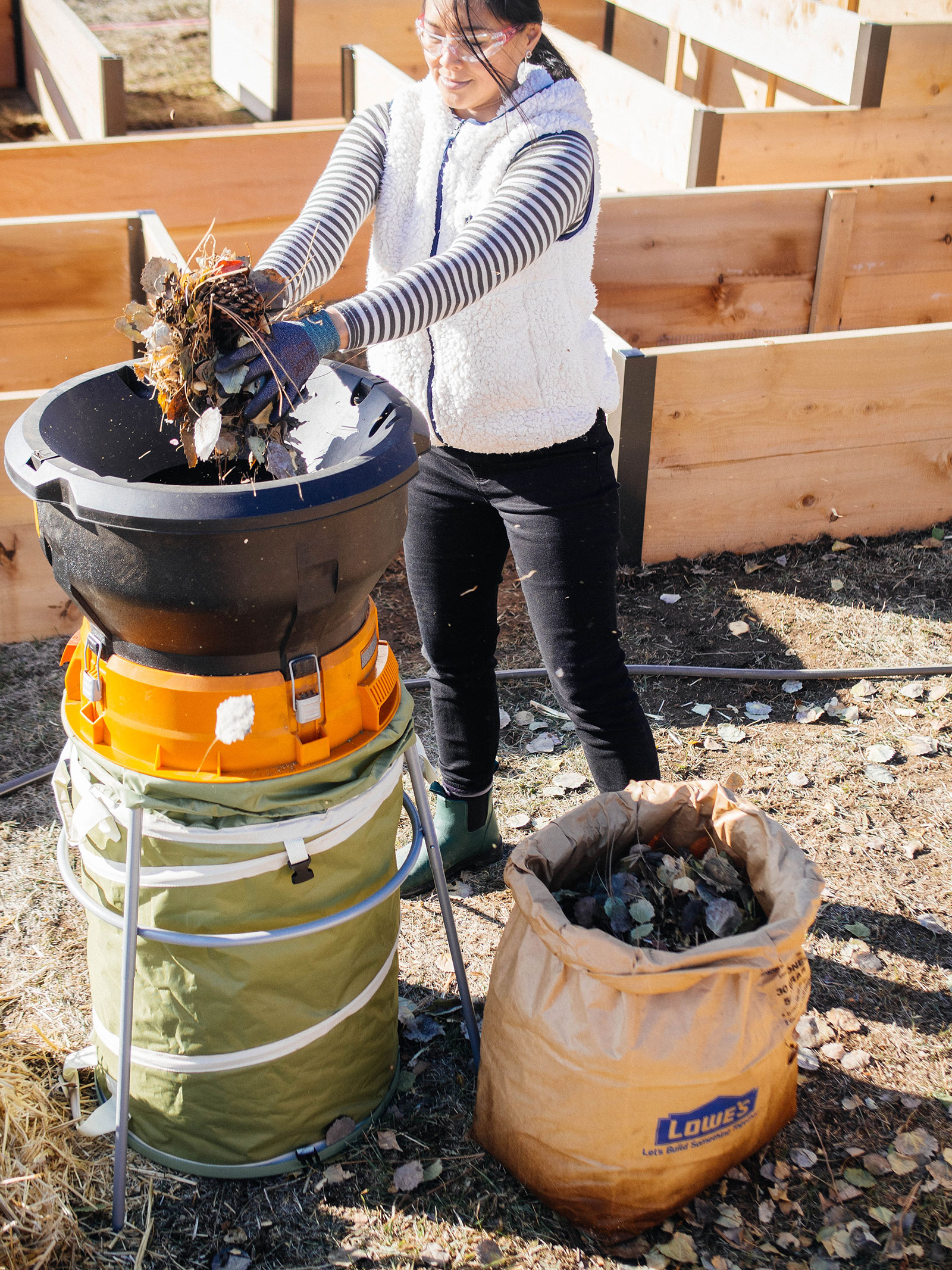 Linda Ly shredding a bag of leaves with the Worx electric leaf mulcher in the garden