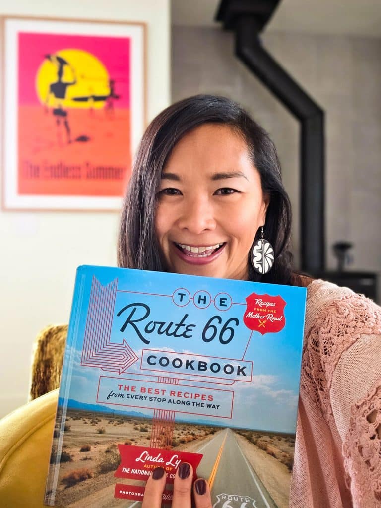 Author Linda Ly holding a copy of The Route 66 Cookbook