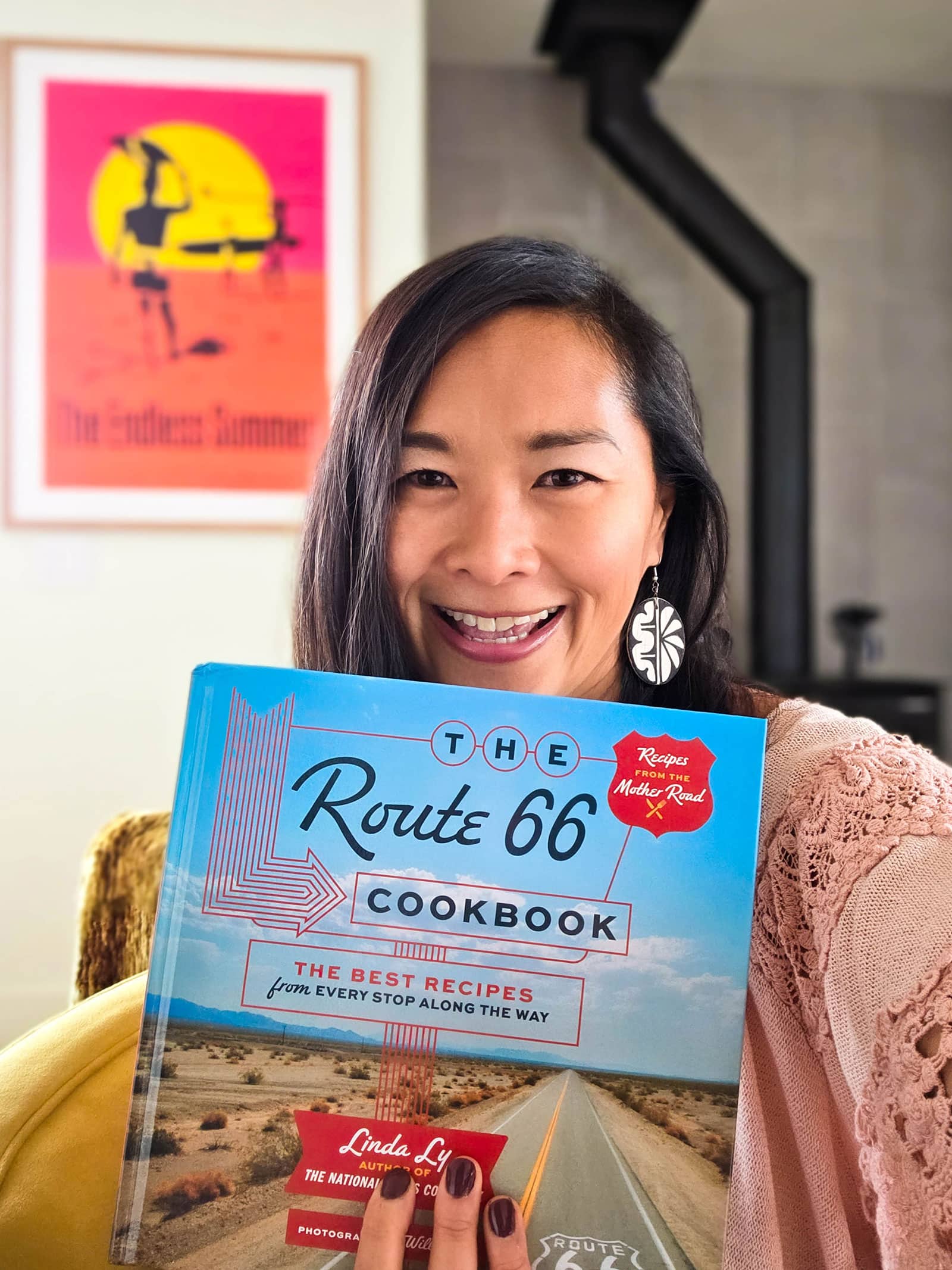 Author Linda Ly holding a copy of The Route 66 Cookbook