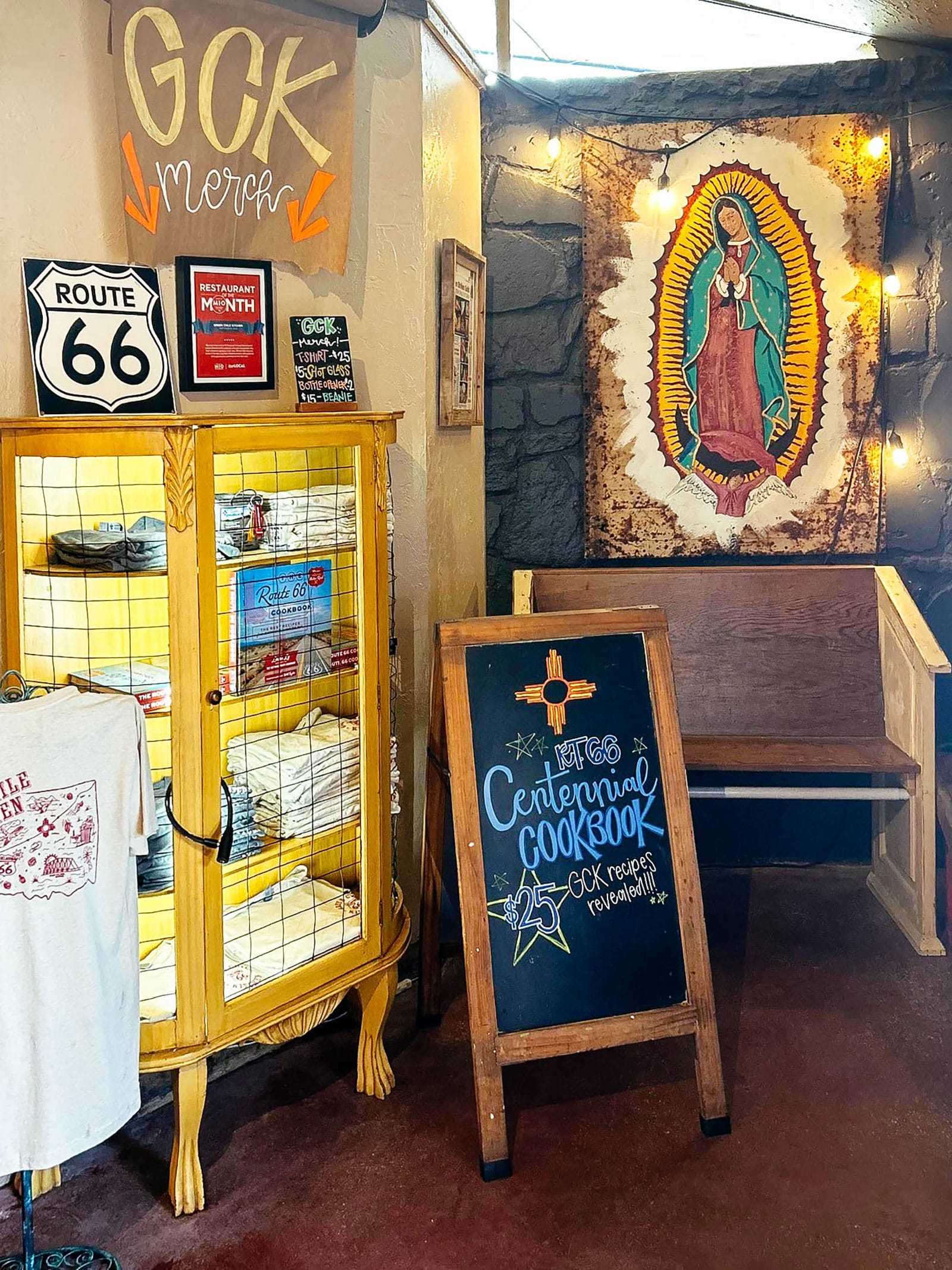 Merchandise display at Green Chile Kitchen restaurant in Yukon, Oklahoma, with The Route 66 Cookbook in a bookcase