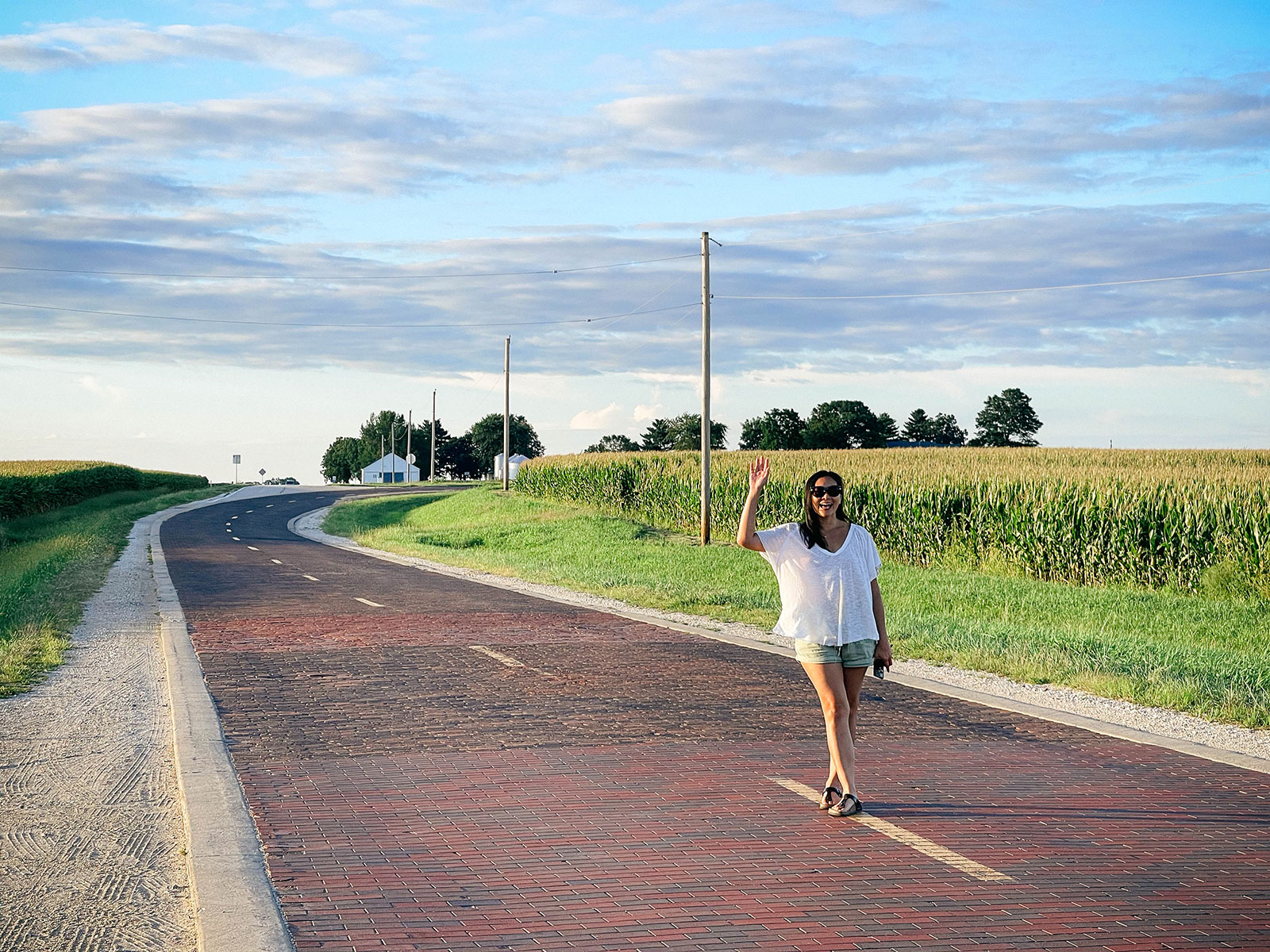 Linda Ly standing on an original red brick road that used to be Route 66