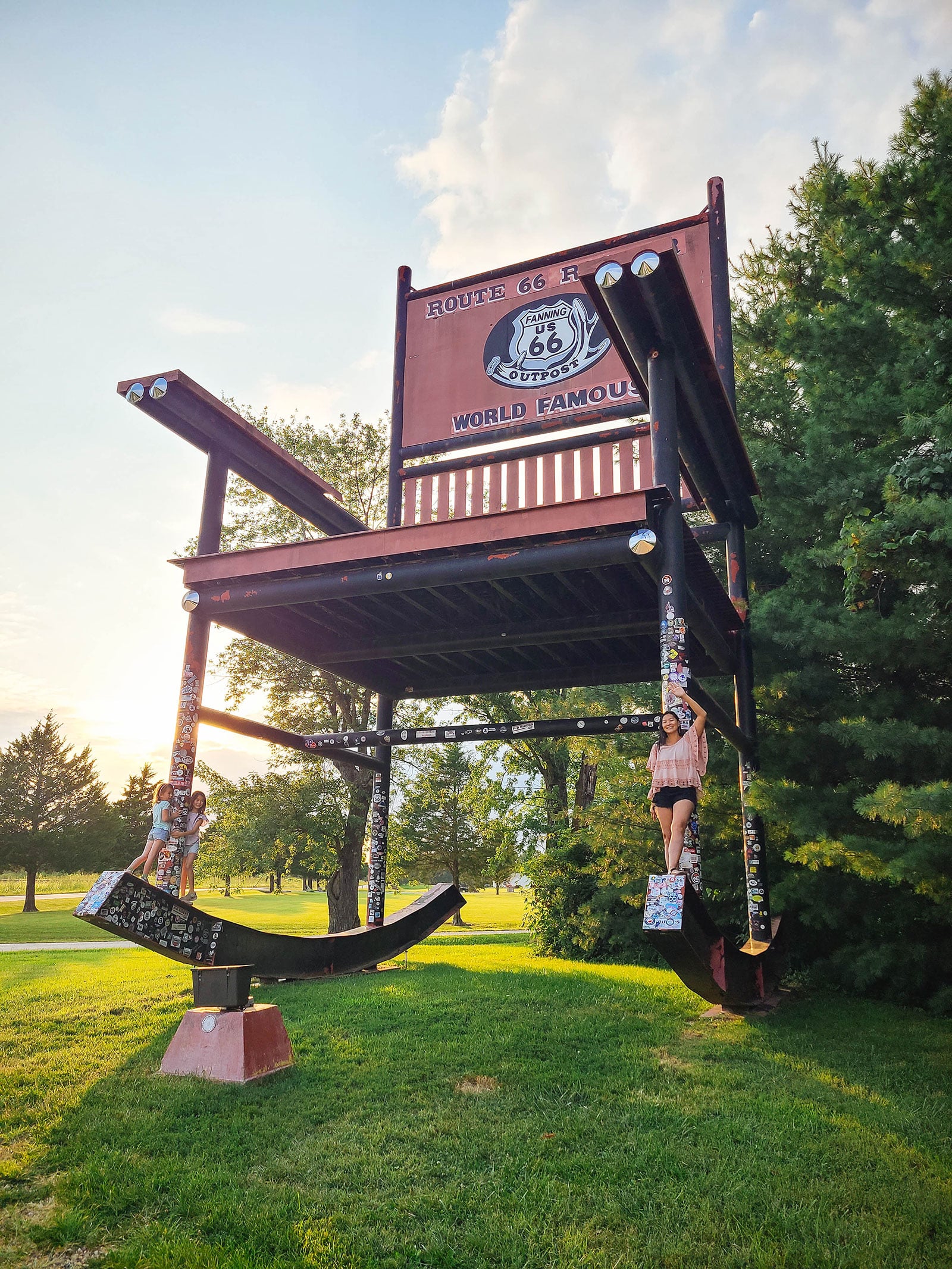 Family posing next to the world's largest rocking chair in Fanning