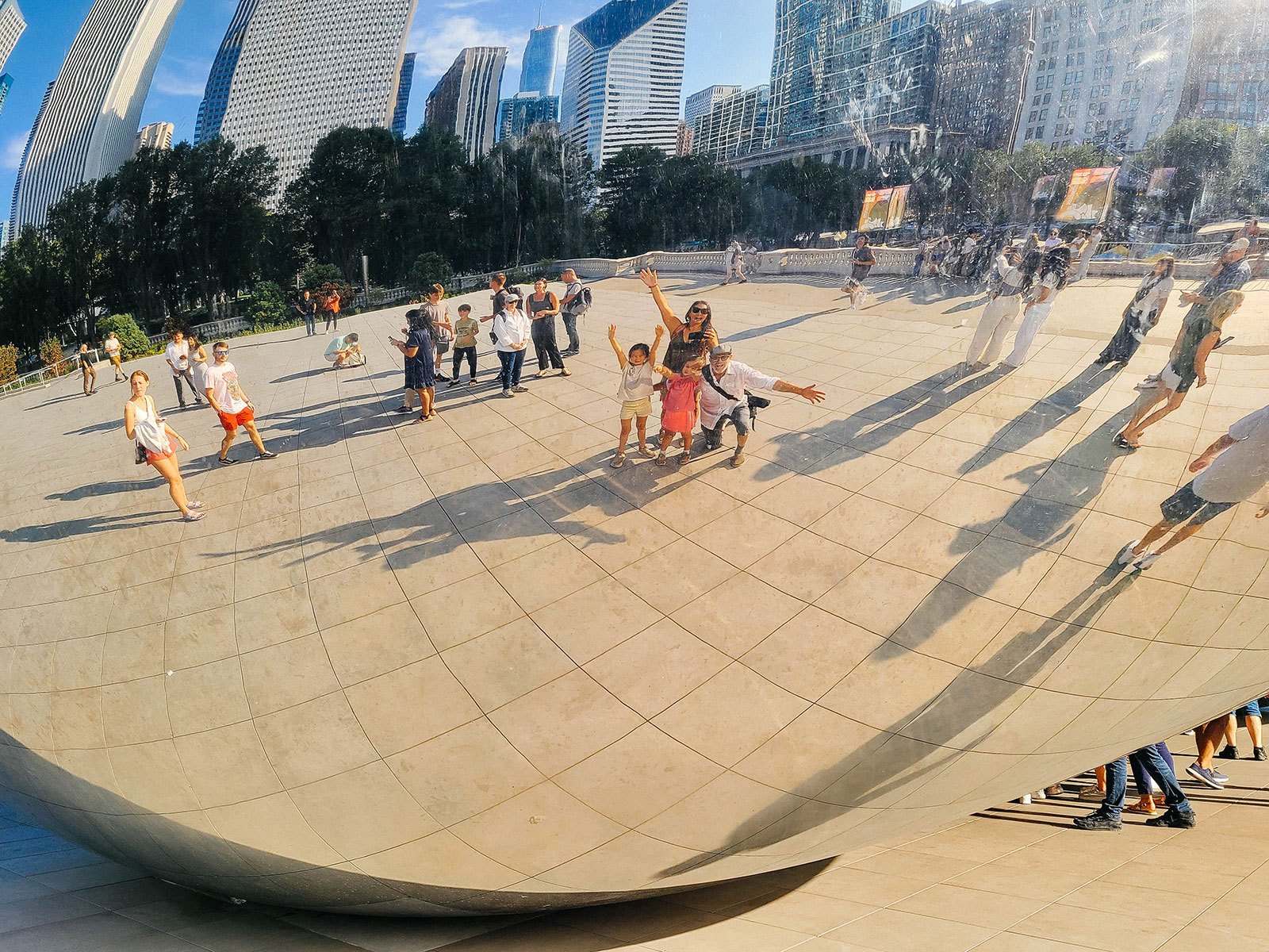 Family posing in front of the The Bean (Cloud Gate) in Chicago's Millennium Park