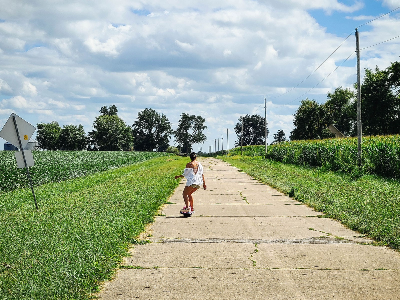 Linda Ly Onewheeling on an original concrete segment of Historic Route 66 in Illinois surrounded by farmland
